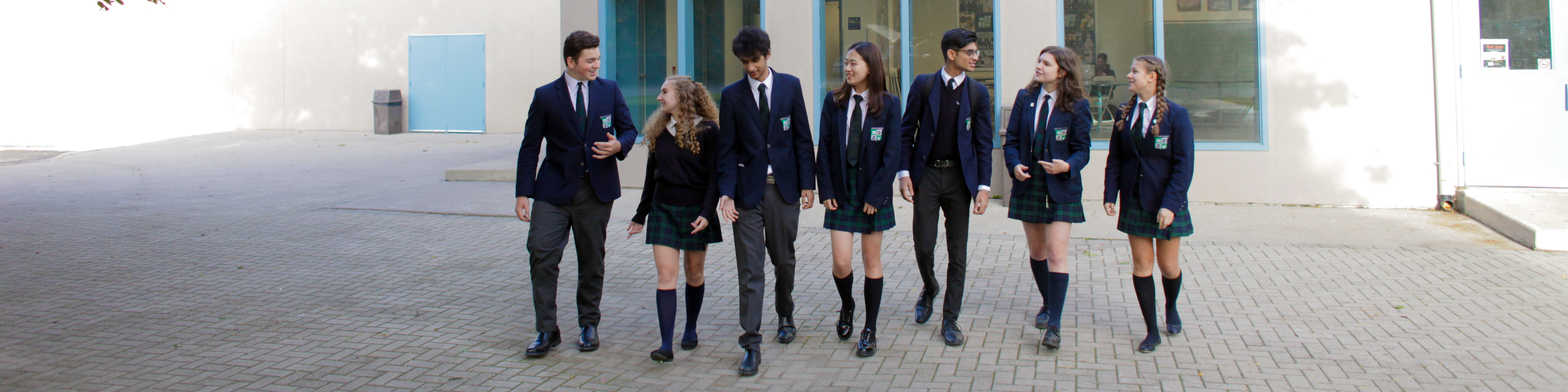 Seven High School students in front of the Main Campus