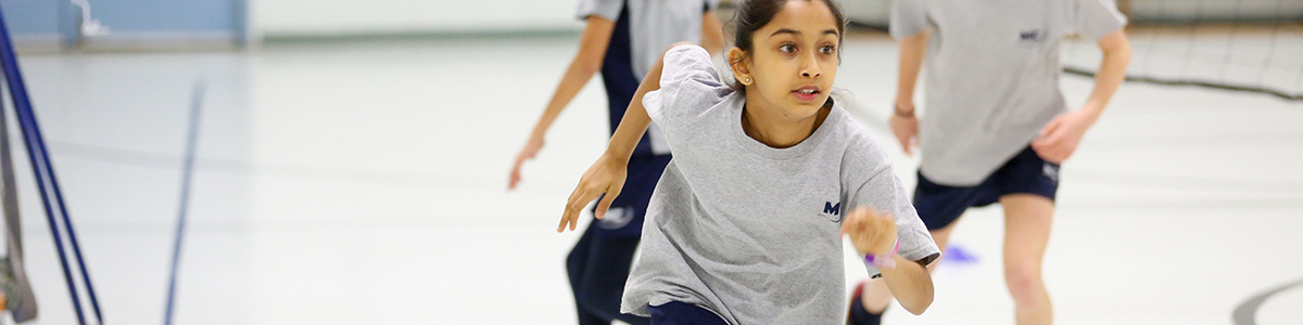 Primary children running in the gym