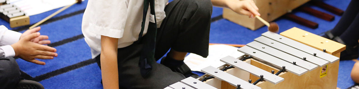 Clode-up shot of student's hand playing xylophone