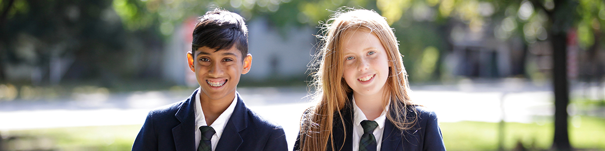 An Intermediate Division boy and girl smiling at the camera