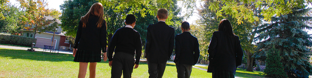 A rearview shot of a group of Intermediate Division children walking on the field 