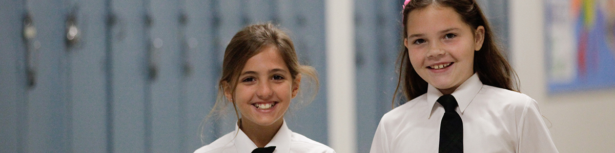 Two Primary children - a boy and a girl - smiling